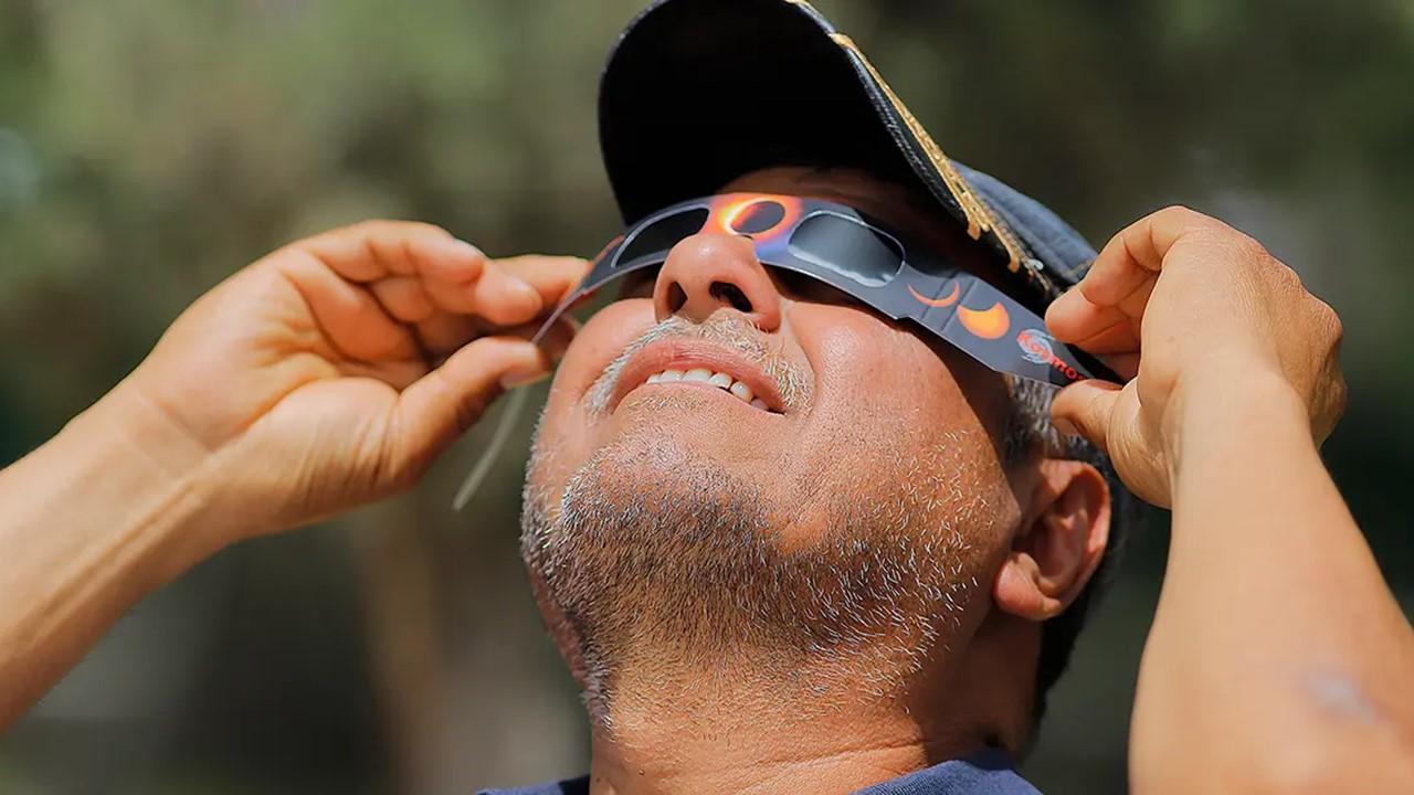 A man using eclipse glasses