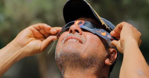 A man using eclipse glasses