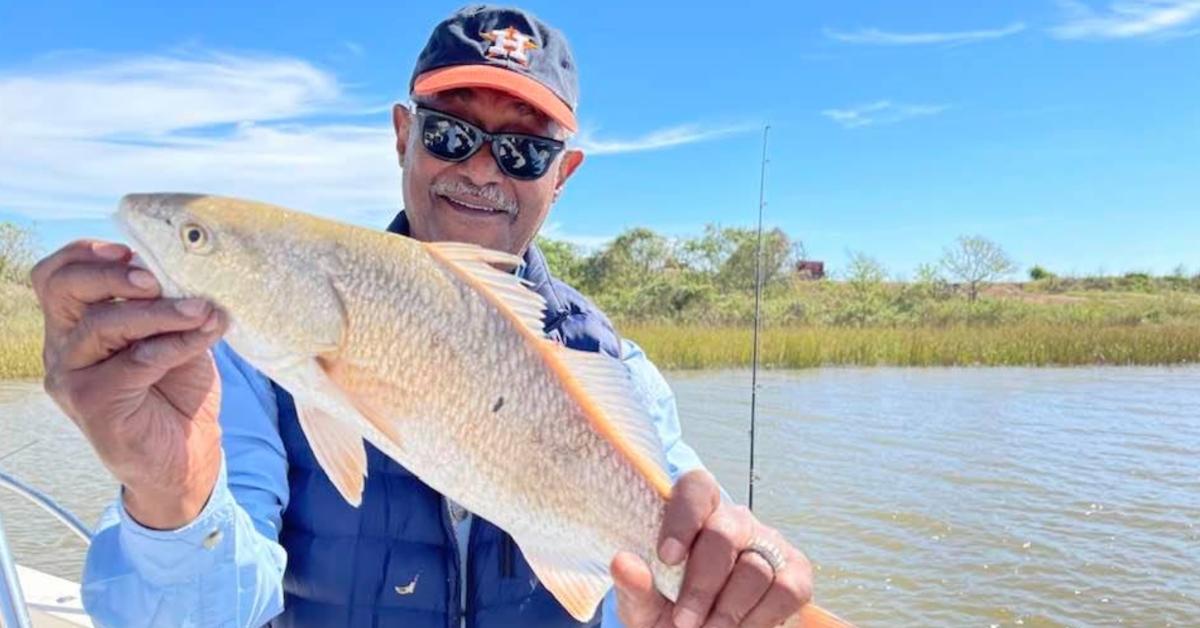 José Griñán holds up a fish he caught