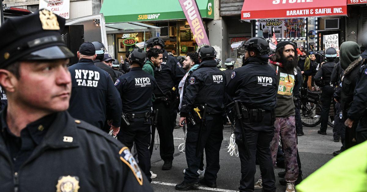 An officer of New York Police Department detains a man at a pro-Palestinian demonstration