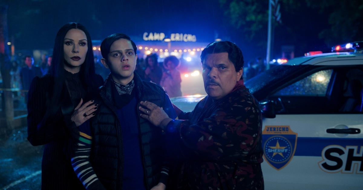 Morticia, Pugsley, and Gomez outside of the school in Wednesday.