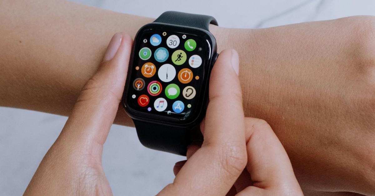 A woman adjusting her Apple Watch