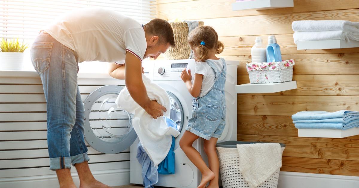 happy family man father householder and child in laundry with washing picture id