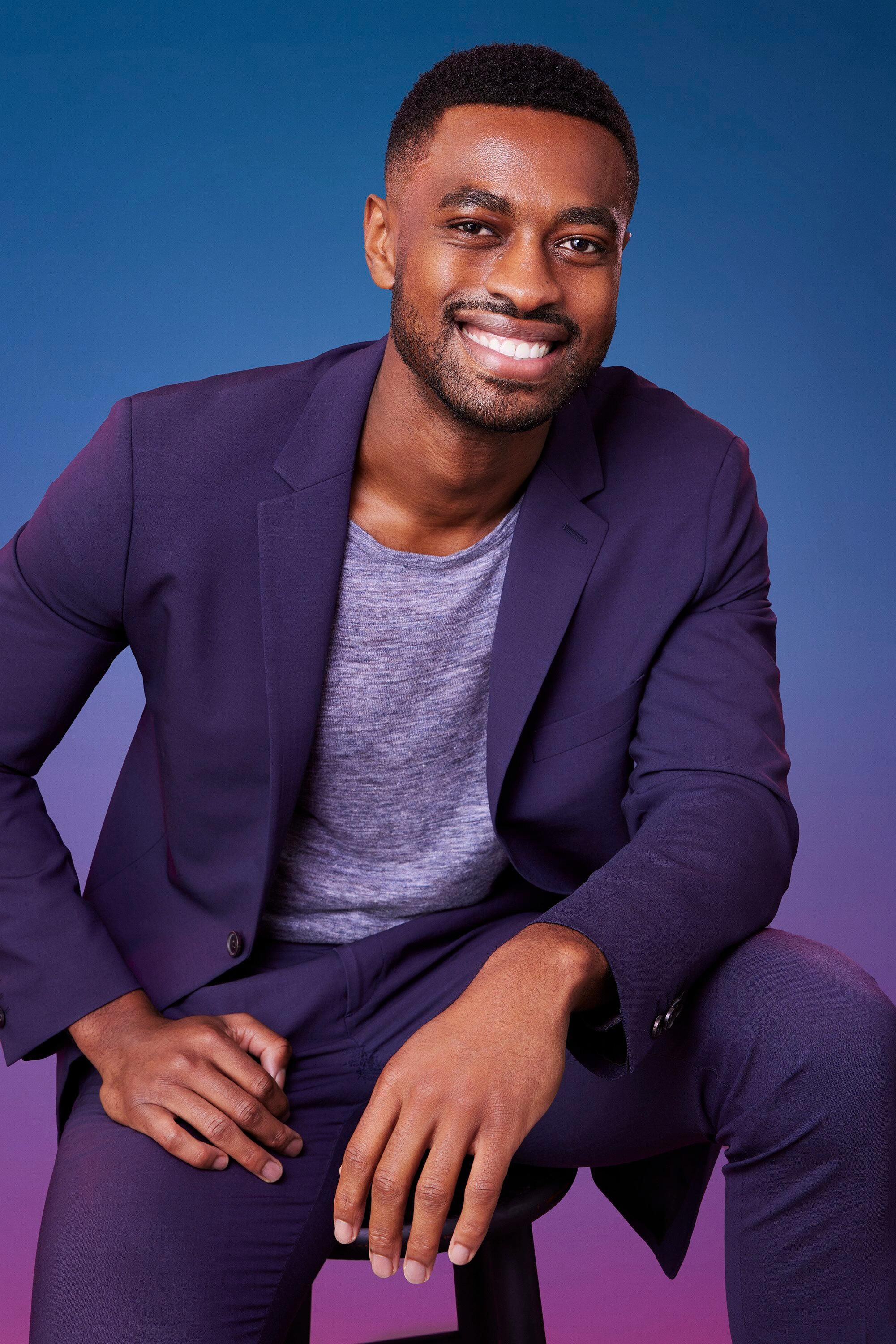 Marvin poses in front of a blue-purple ombré background for his official 'The Bachelorette' Season 21 portrait.