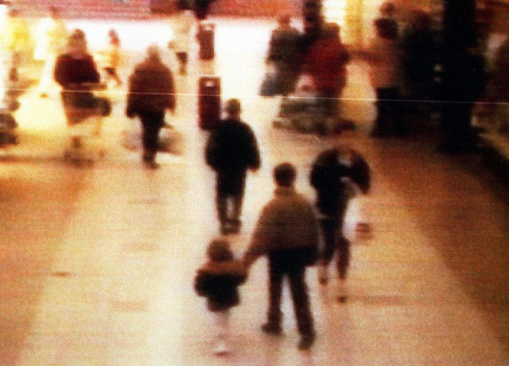 Jon Venables and Robert Thompson leading James Bulger away