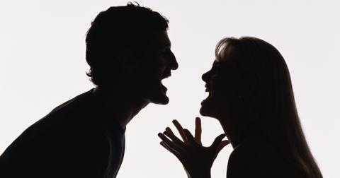 A silhouette of a couple yelling at each other.