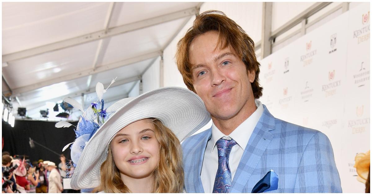 (l-r): Dannielynn Birkhead and Larry Birkhead smiling together in matching blue outfits.