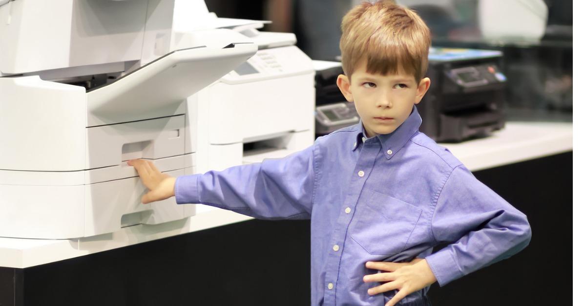 angry boy tired of waiting for the printer to print out his document picture id