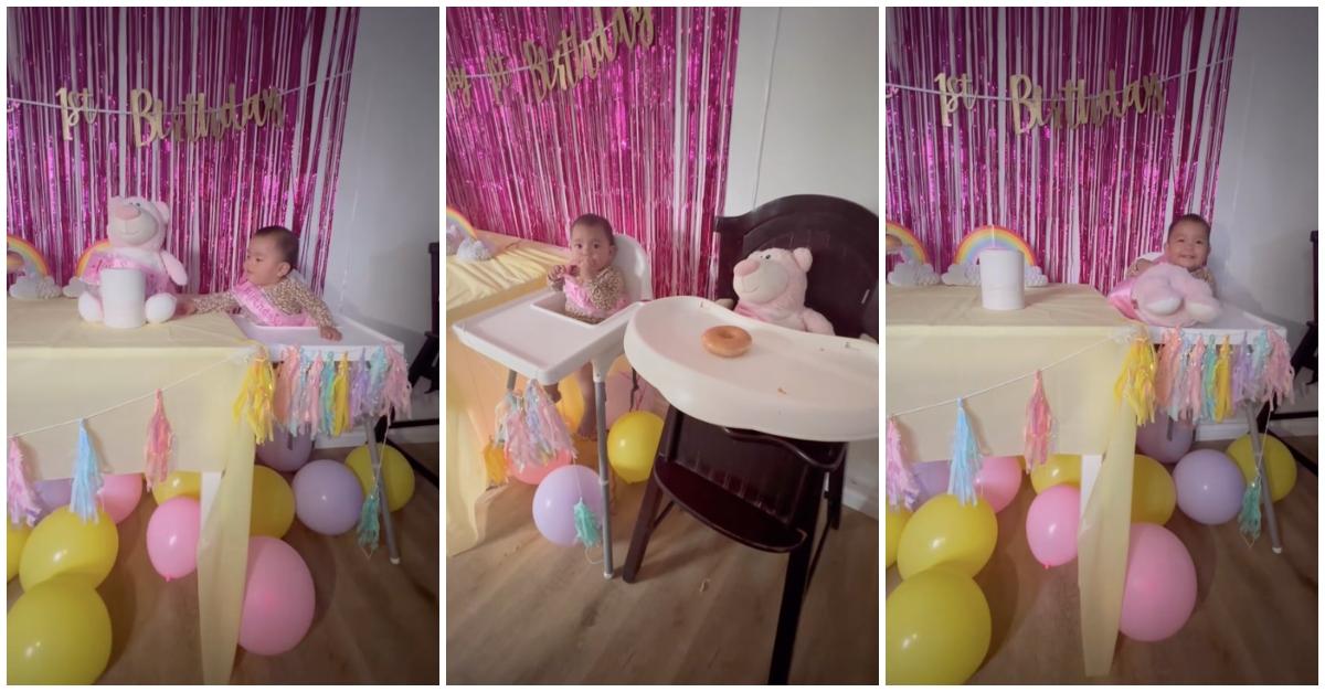 Baby celebrates first birthday with pink decorations and pink teddy bear with her deceased twin sister's heartbeat in it.