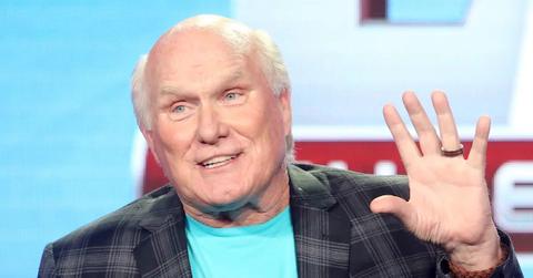 Terry Bradshaw wearing a blue shirt and speaking at an event.