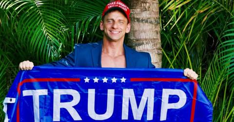 Vitaly holding up a Trump 2024 sign.