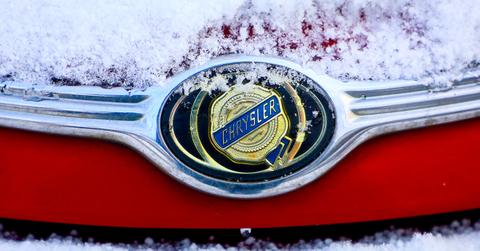 The Chrysler logo on a snow covered car.
