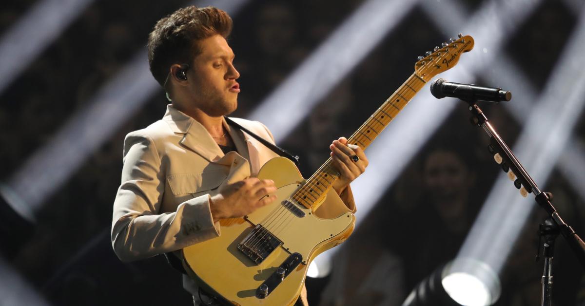 niall horan playing the guitar