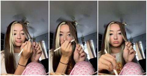 Hooters employee applying brown eye shadow to blonde hair because she won't dye it.