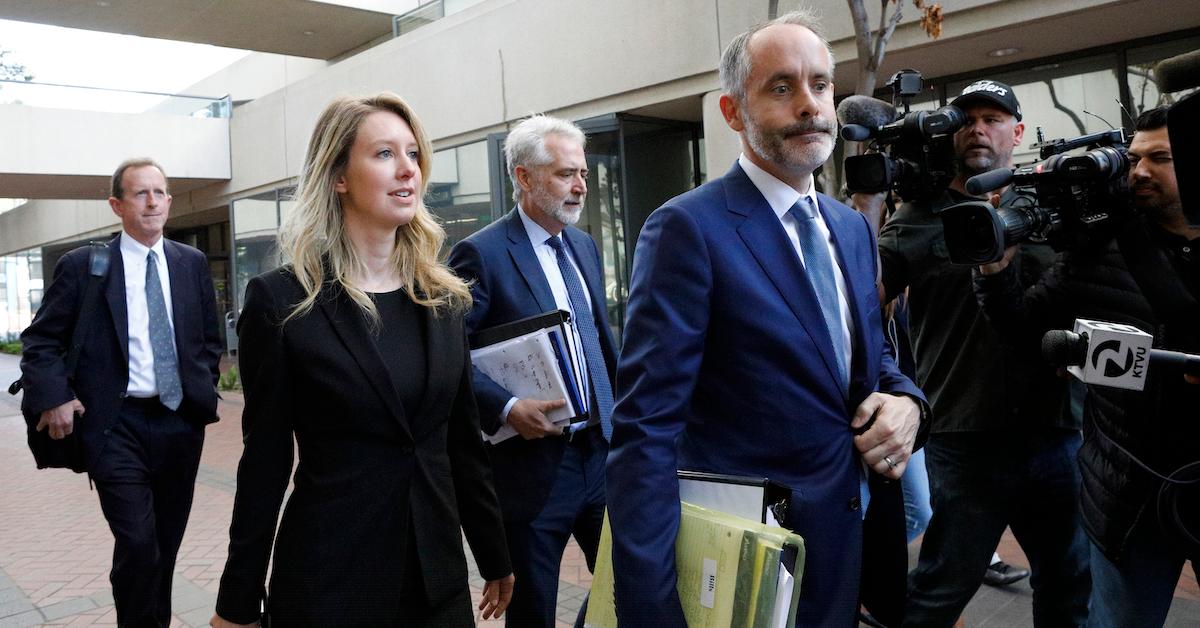 Former Theranos CEO Elizabeth Holmes (2nd L) and lawyer Kevin Downey (2nd R)