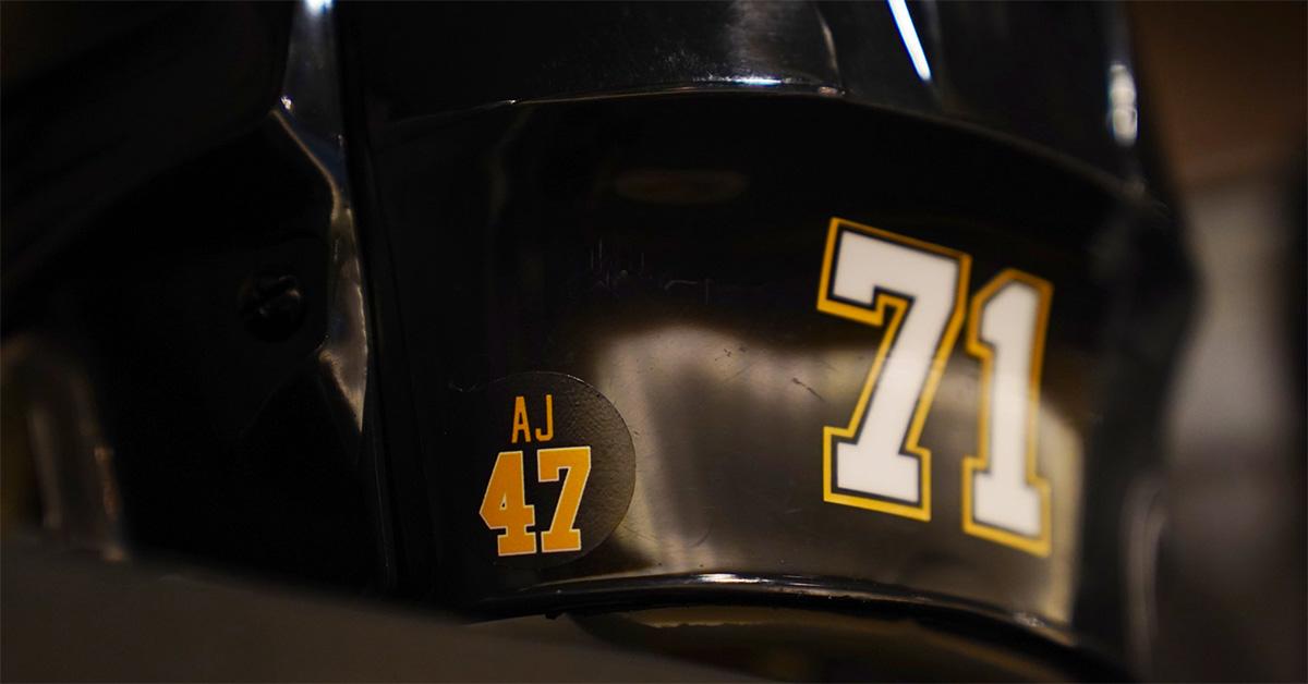 An AJ sticker on a Penguins helmet. 