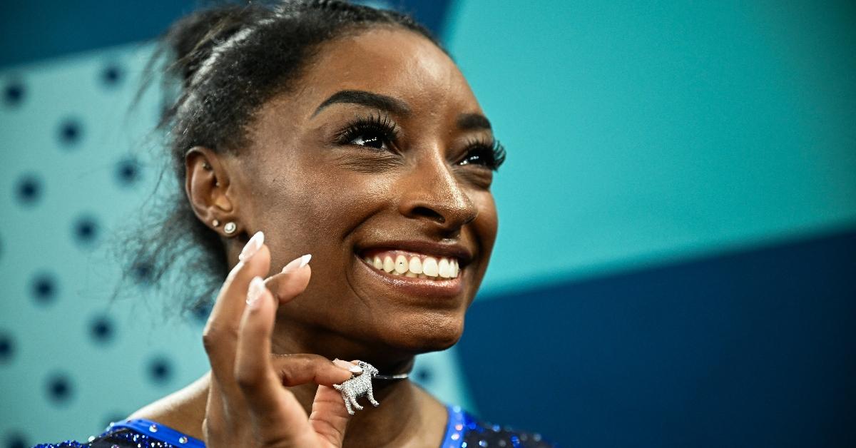 US' Simone Biles poses her goat necklace after the artistic gymnastics women's all around final of the Paris 2024 Olympic Games at the Bercy Arena in Paris, on August 1, 2024. (Photo by Loic VENANCE / AFP) (Photo by LOIC VENANCE/AFP via Getty Images)