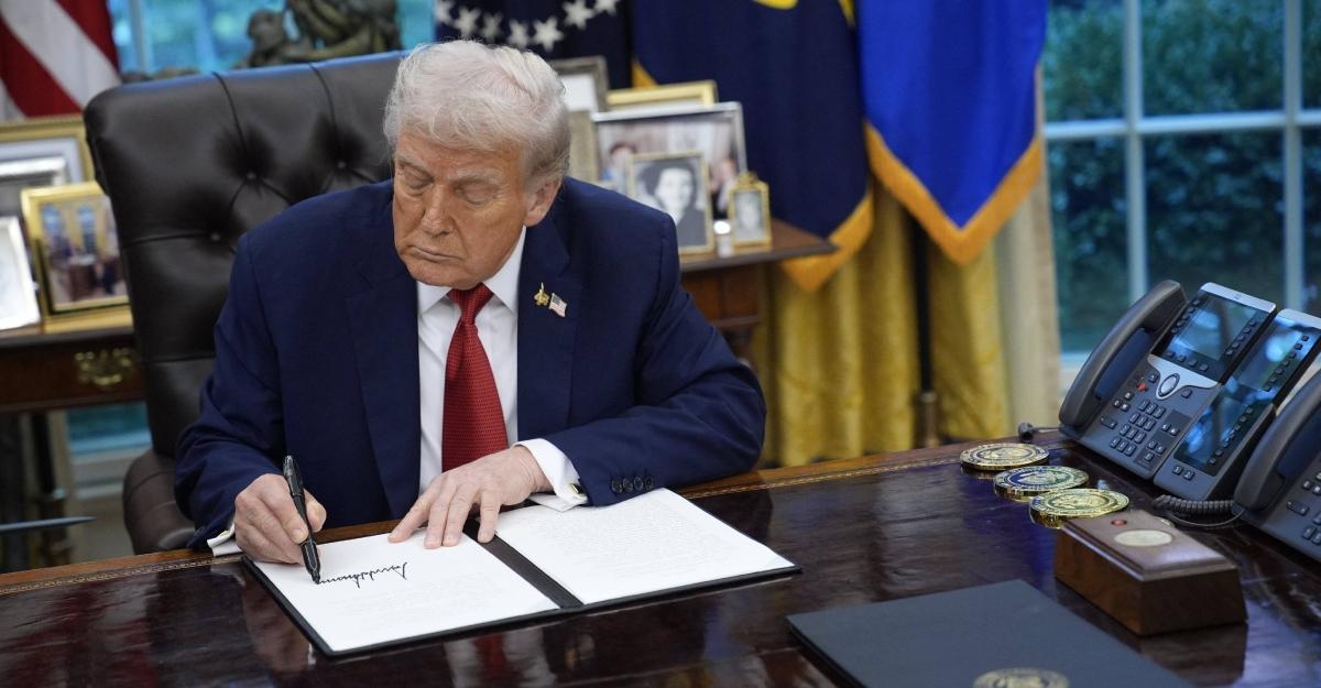 Trump signs an executive order in the Oval Office