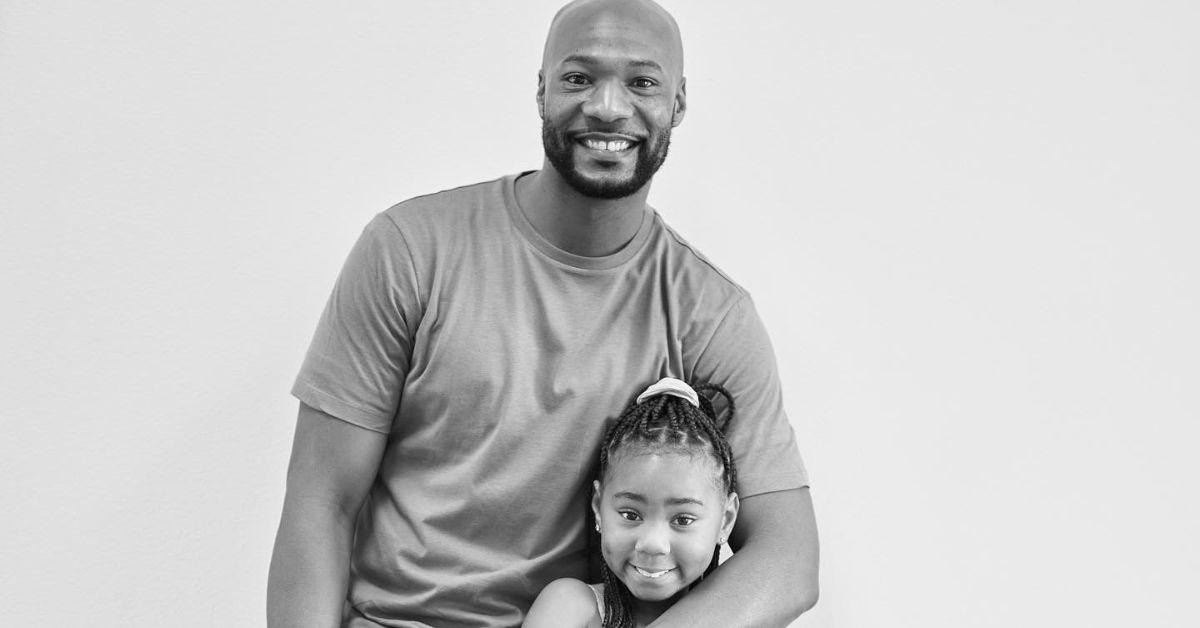 Keion Henderson and his daughter, Kate, posing for the camera. 