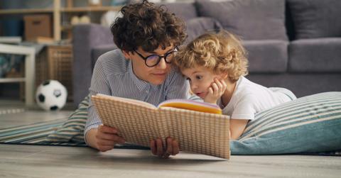 mom reading a book to child