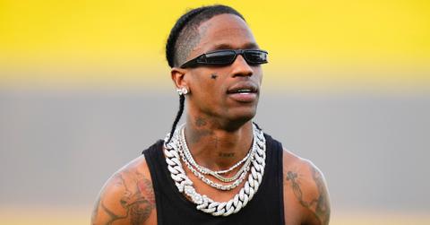 Musician Travis Scott celebrates after throwing the opening pitch.