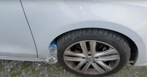 Plastic bottle lodged in between car and tire