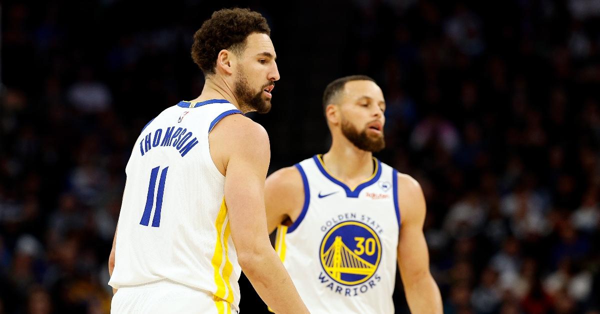 Klay Thompson #11 and Stephen Curry #30 of the Golden State Warriors look on against the Minnesota Timberwolves in the first quarter at Target Center on March 24, 2024 in Minneapolis, Minnesota