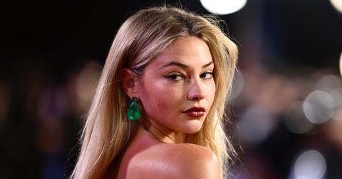 Madelyn Cline attends an event wearing large emerald earrings.