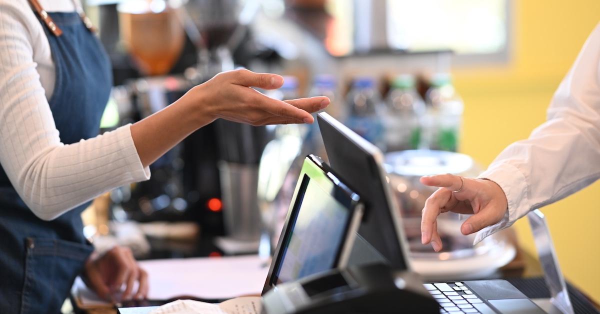 A customer paying a bill at the register