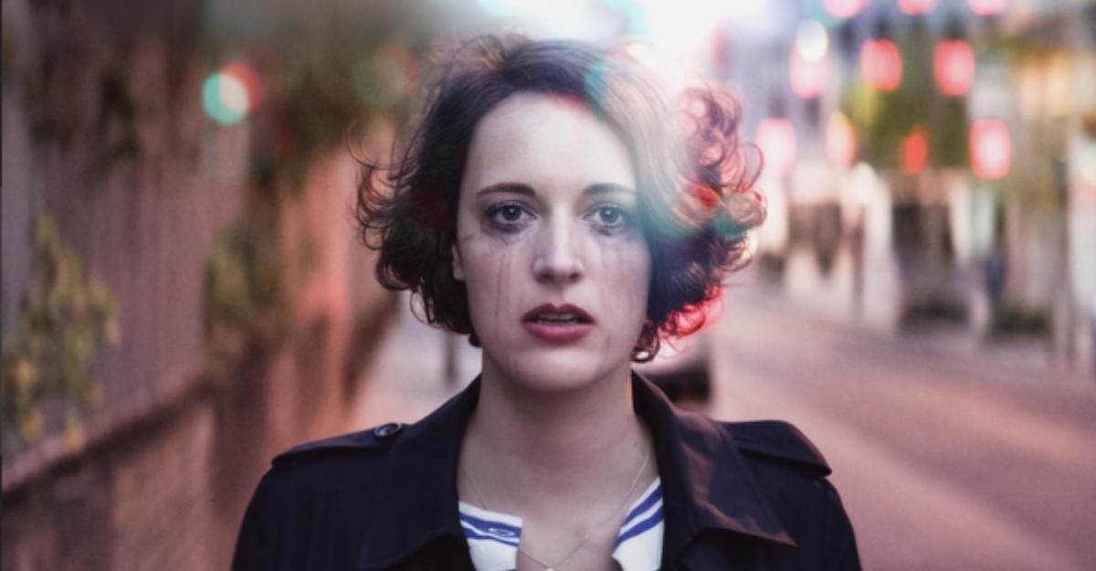 Fleabag stands on a sidewalk with mascara dripping down her face.