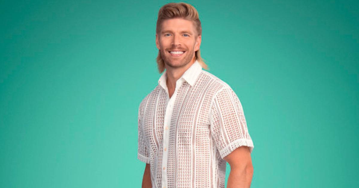 Kyle Cooke smiles and poses for Season 8 of 'Summer House' in a white crochet knit short sleeve button up.