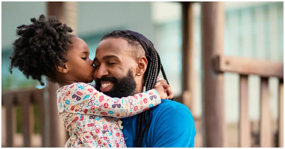 (l-r): A father and daughter embracing