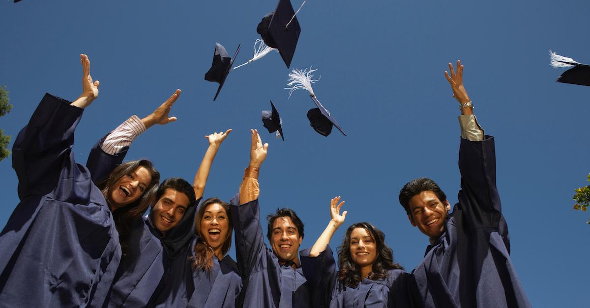 Graduates celebrating in cap and gown