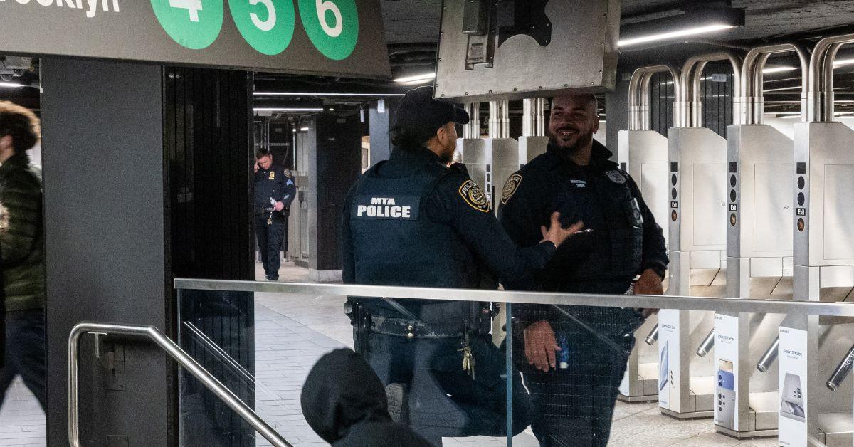 NYPD officers stand in a Manhattan subway station