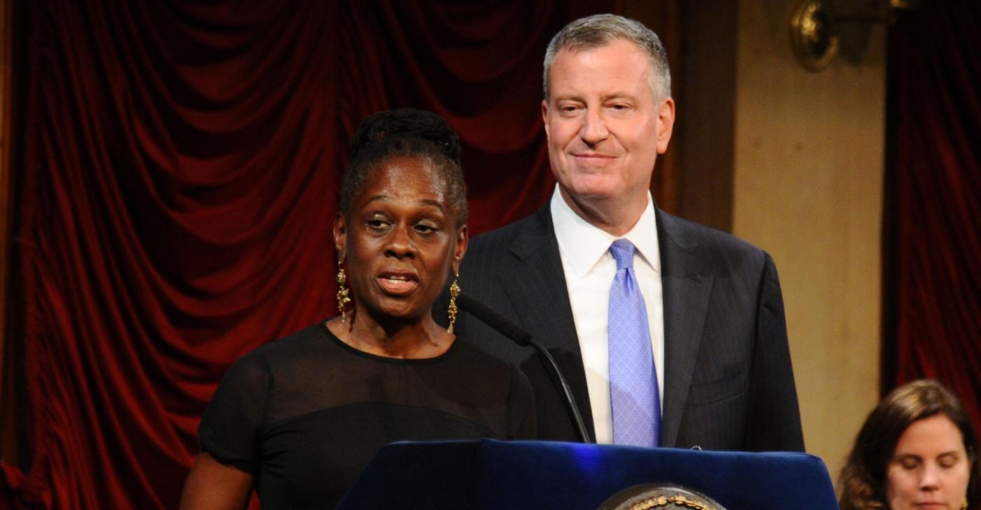 Bill de Blasio (R) looks on as wife Chirlane McCray speaks onstage during the "Made In NY" Awards 2014