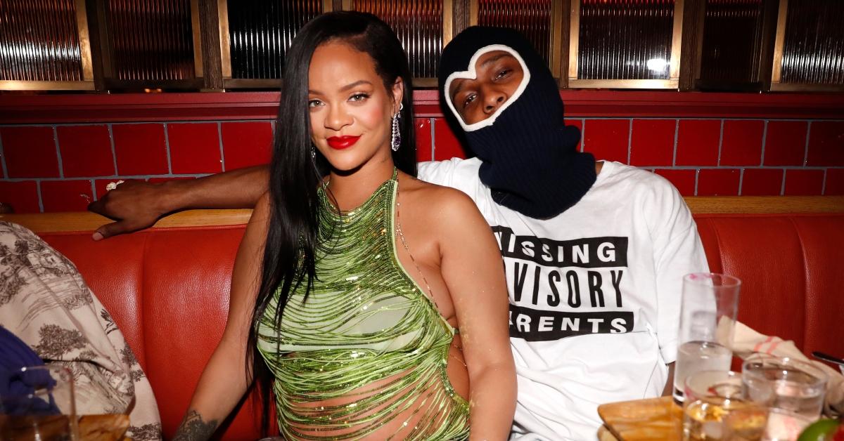 A pregnant Rihanna and A$AP Rocky sit together at a restaurant,