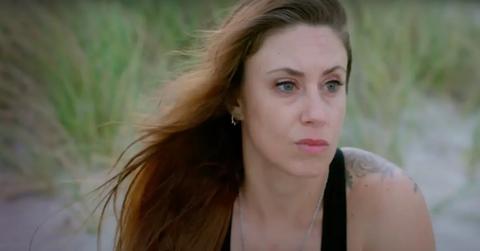 Casey Anthony sitting in the sand.