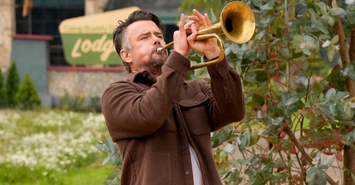 Josh Duhamel playing a trumpet on 'Buddy Games.'