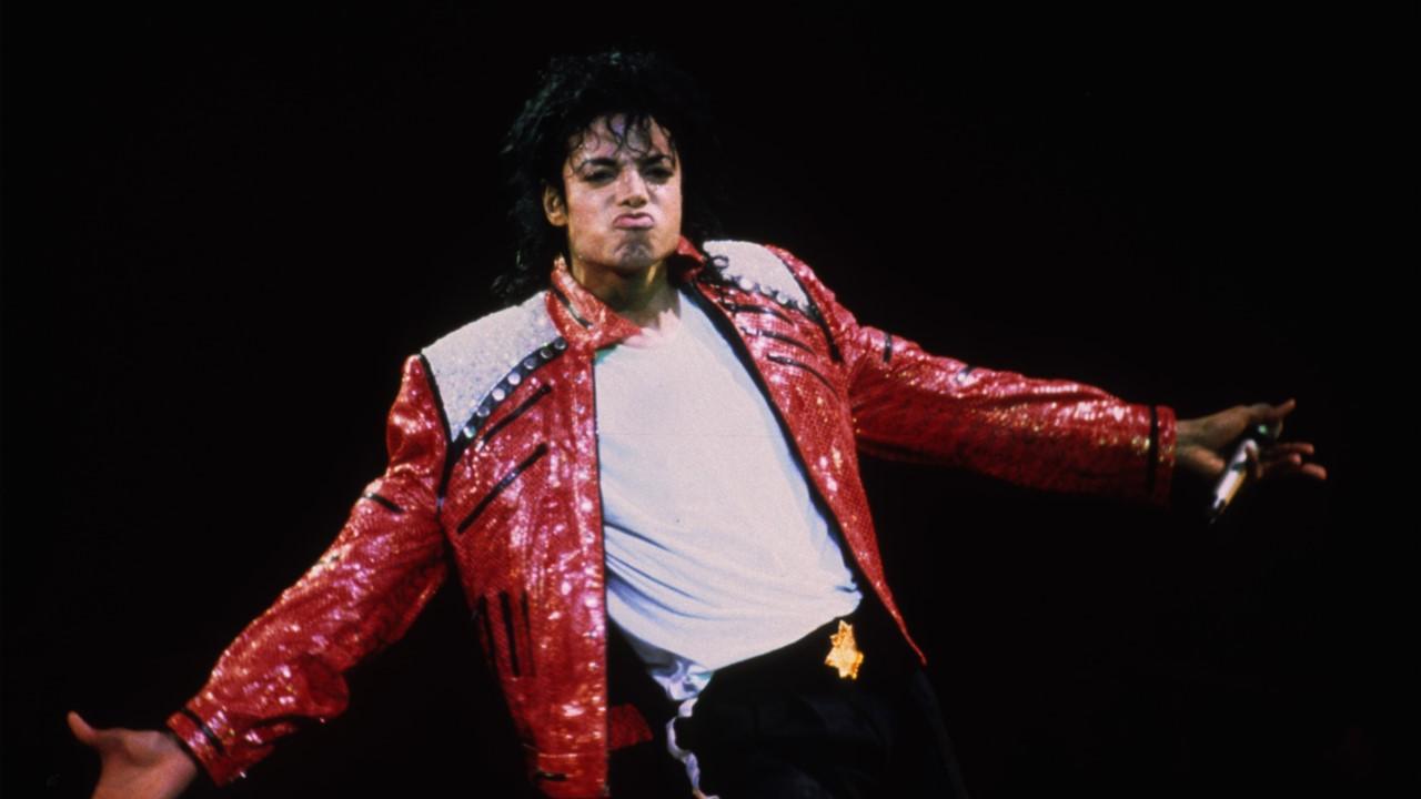 Michael Jackson performing in a red jacket in 1986