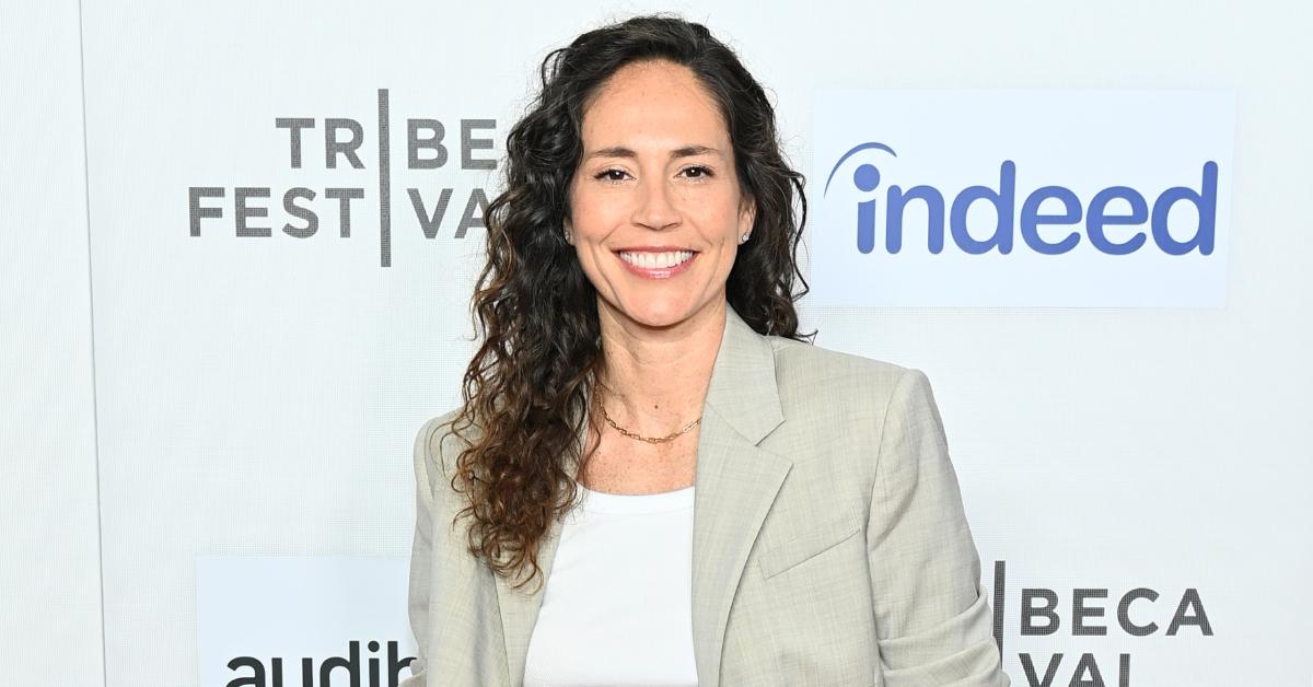 Sue Bird poses on the red carpet in a cream suit at the 'Power Of The Dream' premiere during the 2024 Tribeca Festival at SVA Theater on June 13, 2024, in New York City.