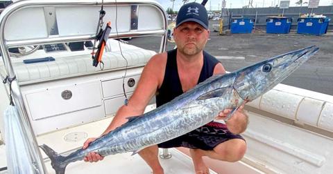 Rick Shelford from 'Deadliest Catch' on a fishing boat holding an ono fish