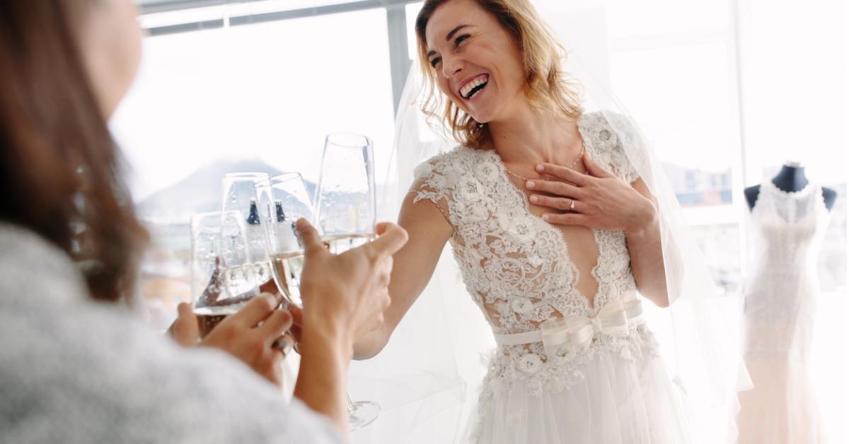 bride toasting champagne with friends in bridal boutique picture id