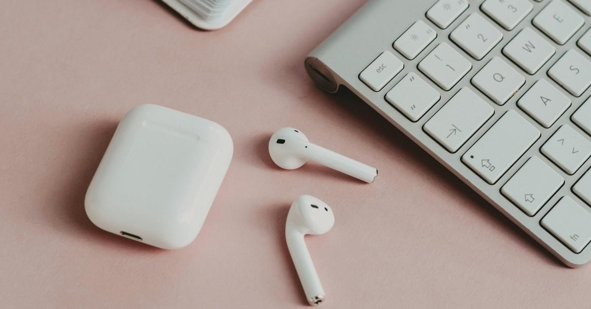 Air Pods on a pink table