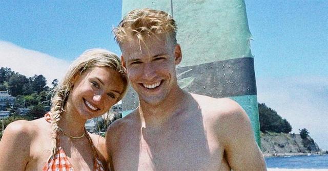 Cameron Brink and Ben Felter posing for a photo on the beach together.