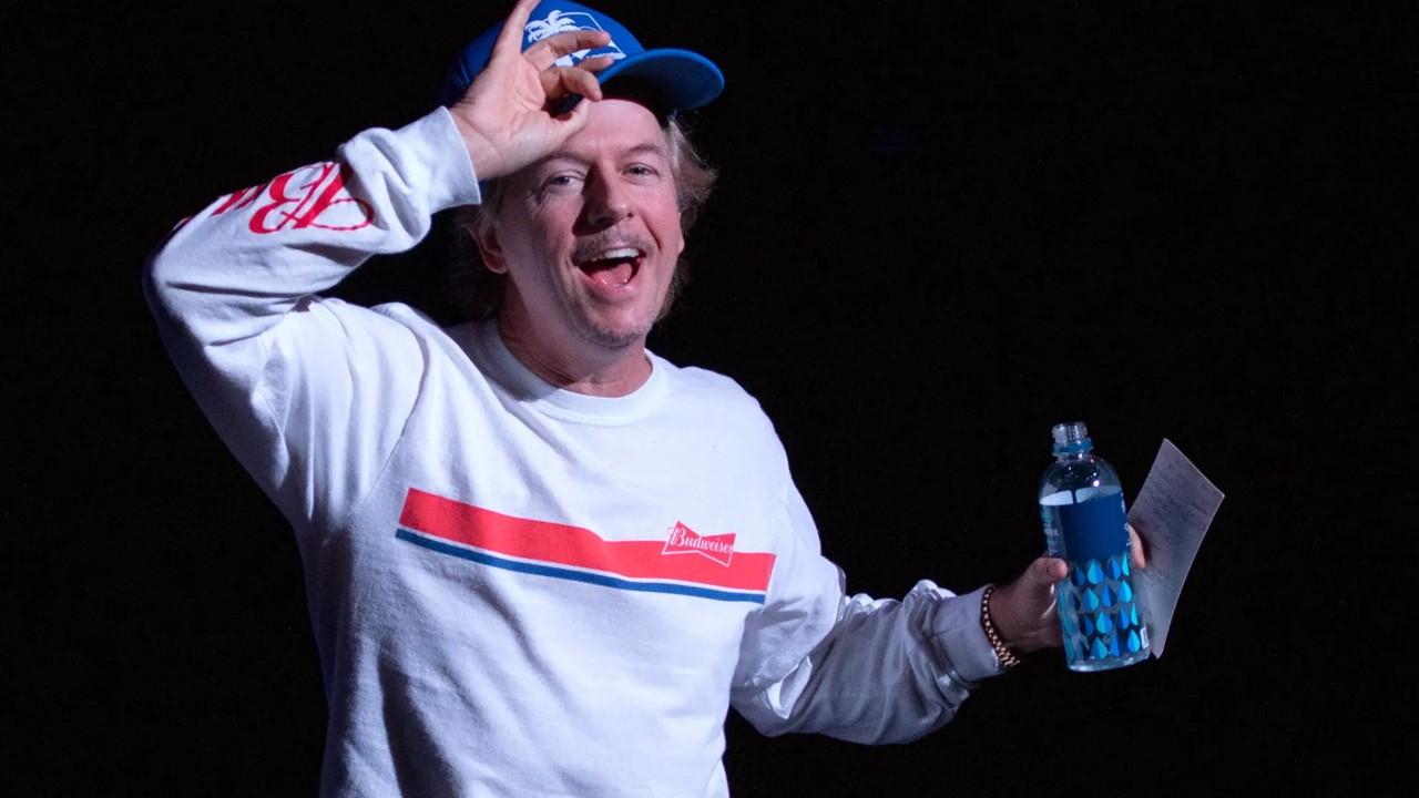 David Spade on stage at a comedy show