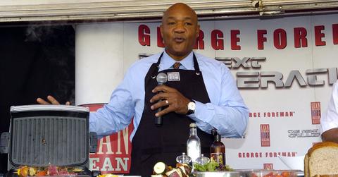 George Foreman talking and pointing at his grill.
