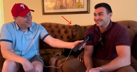 "Tan Mom" blends into her leather couch.