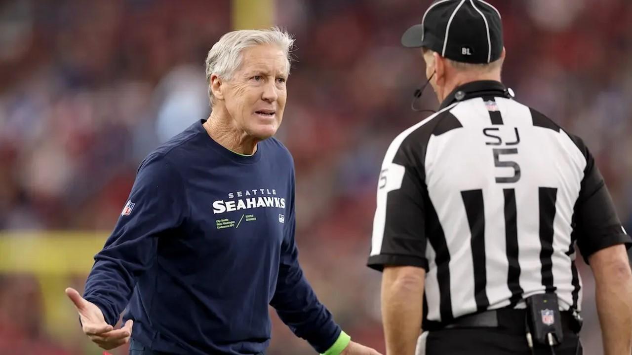 Seattle Seahawks head coach Pete Carroll talks with side judge Jim Quirk #5 during the Arizona Cardinals game on Jan. 7, 2024