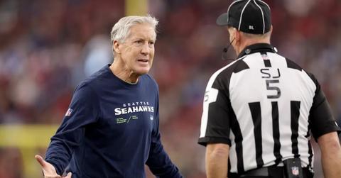 Seattle Seahawks head coach Pete Carroll talks with side judge Jim Quirk #5 during the Arizona Cardinals game on Jan. 7, 2024