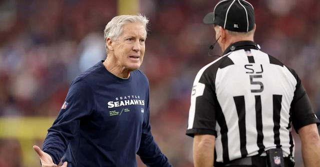 Seattle Seahawks head coach Pete Carroll talks with side judge Jim Quirk #5 during the Arizona Cardinals game on Jan. 7, 2024